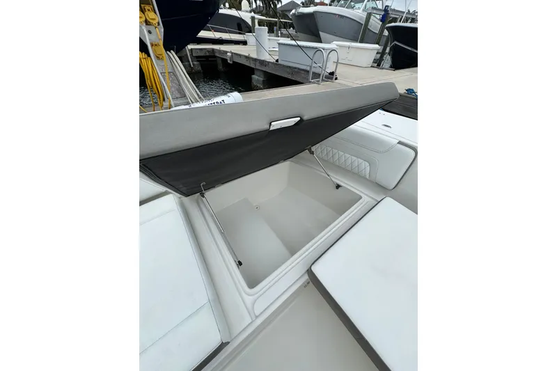 Slide: The Image of Open storage compartment on 2022 World Cat 325 DC boat at marina. - 27