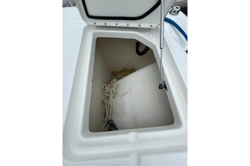 Slide: The Image of Open storage compartment on 2022 World Cat 325 DC boat with rope inside. - 29