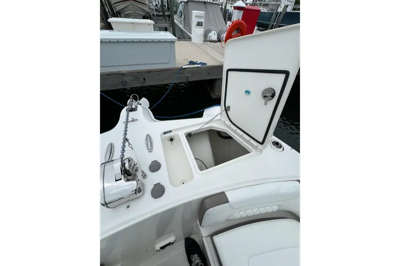 Slide: The Image of Open storage compartment on a 2022 World Cat 325 DC boat at a dock. - 31