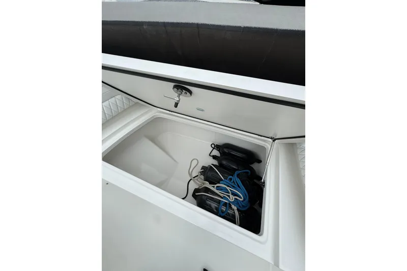 Slide: The Image of Open storage compartment on a 2022 World Cat 325 DC boat at a dock. - 34