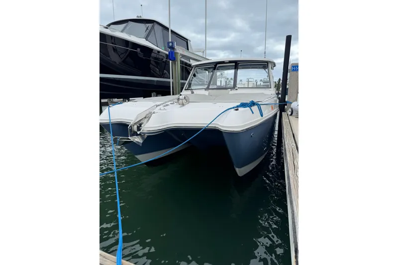 Slide: The Image of 2022 World Cat 325 DC boat docked in marina, front view. - 4