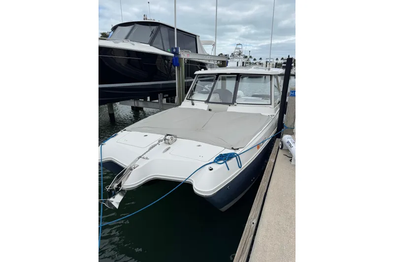 Slide: The Image of 2022 World Cat 325 DC boat interior with white seating and cup holders. - 6