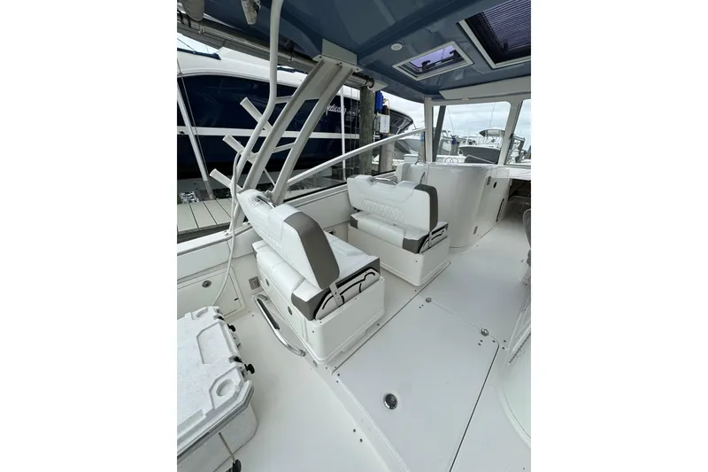 Slide: The Image of 2022 World Cat 325 DC boat interior with white seating and modern design. - 8