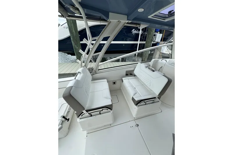 Slide: The Image of 2022 World Cat 325 DC boat interior with white seating and sleek design. - 9
