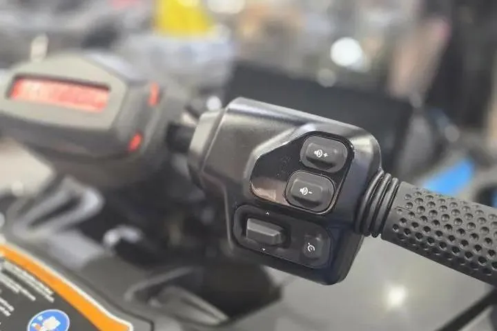 Slide: The Image of Close-up of 2026 Sea-Doo RXT-X 325 handlebar controls, showcasing buttons and grip design. - 19