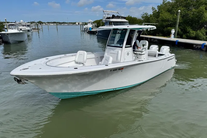 The Image of 2024 Sportsman Open 262 Center Console boat docked in a serene marina setting. - 0