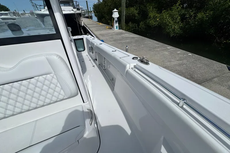 Slide: The Image of 2024 Sportsman Open 262 Center Console boat interior with white seating and sleek design. - 15