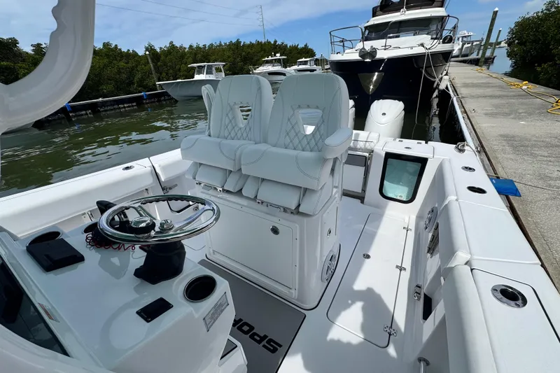 Slide: The Image of 2024 Sportsman Open 262 Center Console boat docked, featuring sleek seating and modern controls. - 16