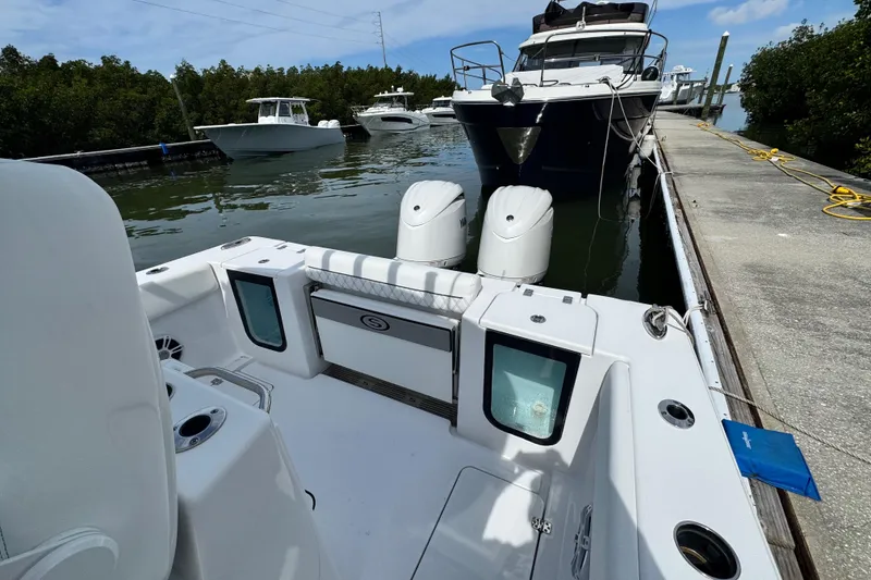 Slide: The Image of 2024 Sportsman Open 262 Center Console docked, showcasing sleek design and dual engines. - 18
