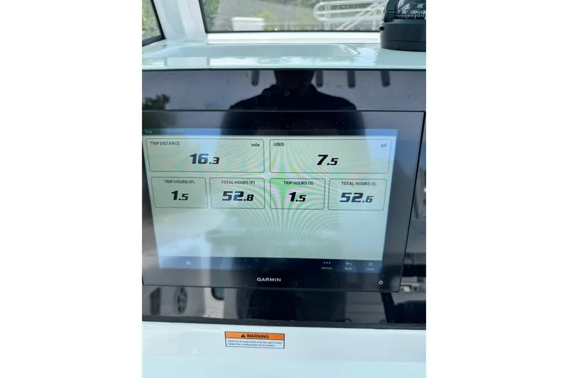 Slide: The Image of 2024 Sportsman Open 262 Center Console dashboard displaying trip data on Garmin screen. - 26