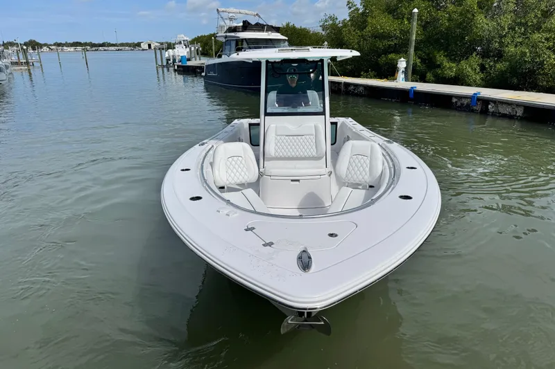 Slide: The Image of 2024 Sportsman Open 262 Center Console boat docked in calm waters. - 3