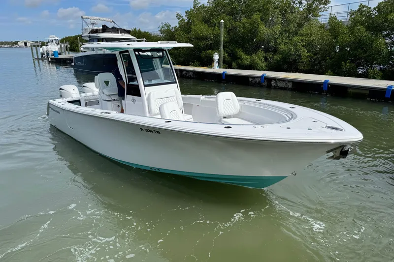 Slide: The Image of 2024 Sportsman Open 262 Center Console boat docked in calm waters. - 4
