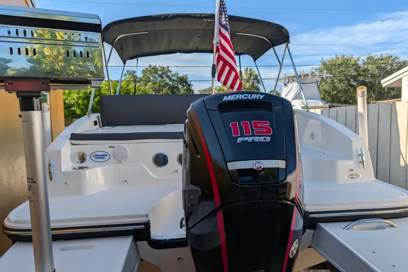 Slide: The Image of 2022 Bayliner DX 2000 boat with Mercury 115 Pro outboard motor and American flag. - 15