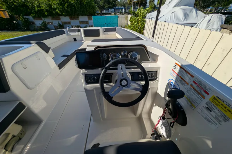 Slide: The Image of 2022 Bayliner DX 2000 boat cockpit with steering wheel and control panel. - 4