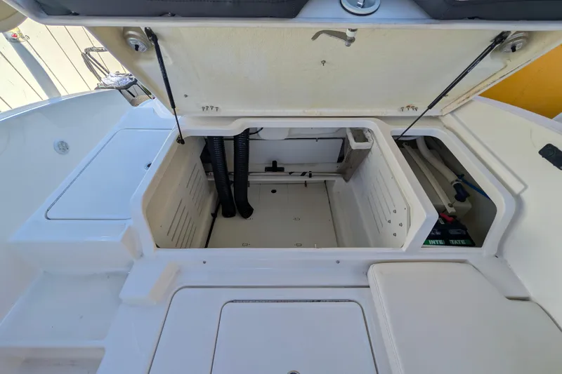 Slide: The Image of 2022 Bayliner DX 2000 boat storage compartment with open hatch and visible interior features. - 8