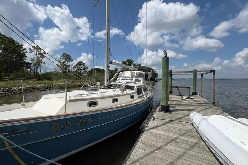 Slide: The Image of Sailboat "Blue Moon" docked, Gozzard 41 RC, 2016 model, under a partly cloudy sky. - 5