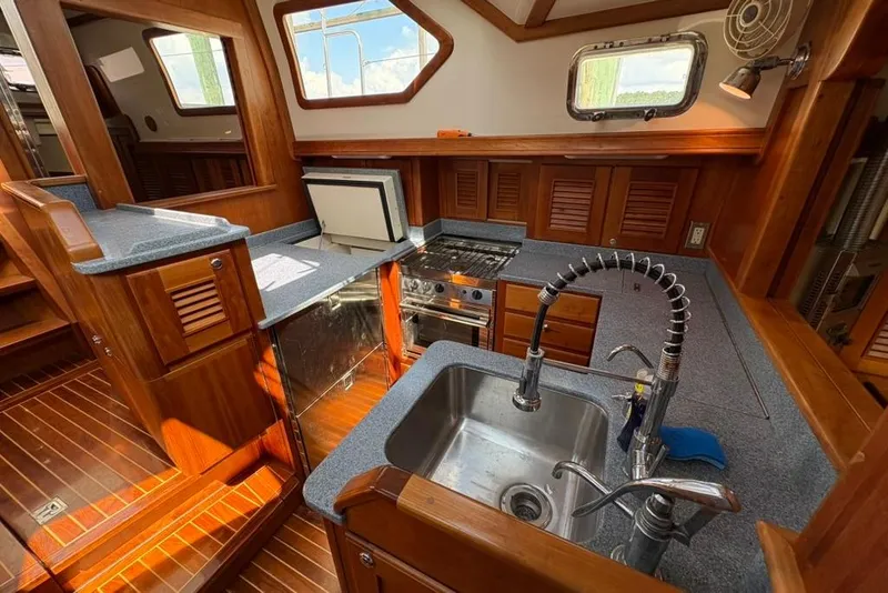 Slide: The Image of Luxurious 2016 Gozzard 41 RC yacht interior kitchen with wood cabinetry and modern appliances. - 11