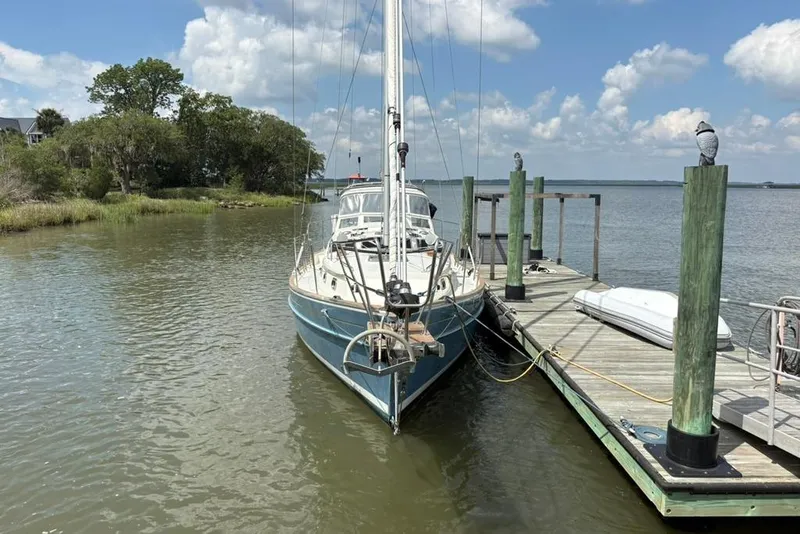 Slide: The Image of Sailboat Gozzard 41 RC (2016) docked by a wooden pier on a sunny day. - 3
