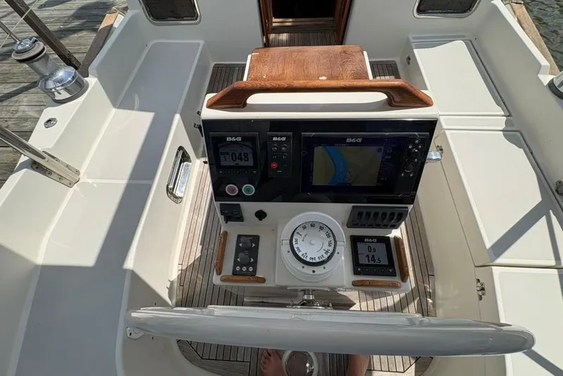 Slide: The Image of Cockpit of 2016 Gozzard 41 RC sailboat with navigation instruments and wooden accents. - 33