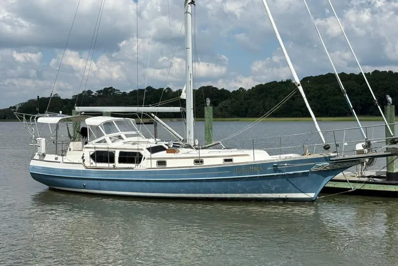 The Image of Sailboat Gozzard 41 RC 2016 docked on calm water under cloudy sky. - 0