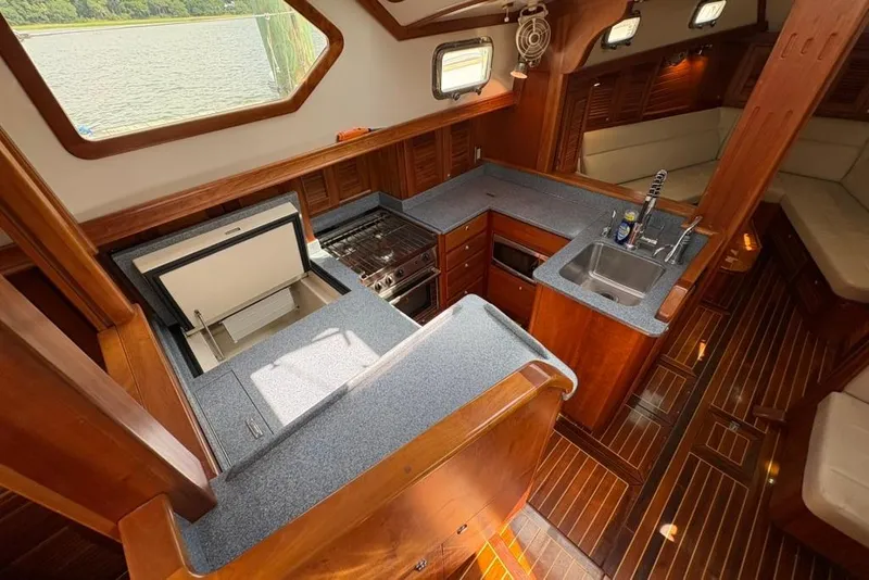 Slide: The Image of Luxurious 2016 Gozzard 41 RC yacht interior with modern kitchen and elegant wood finish. - 12