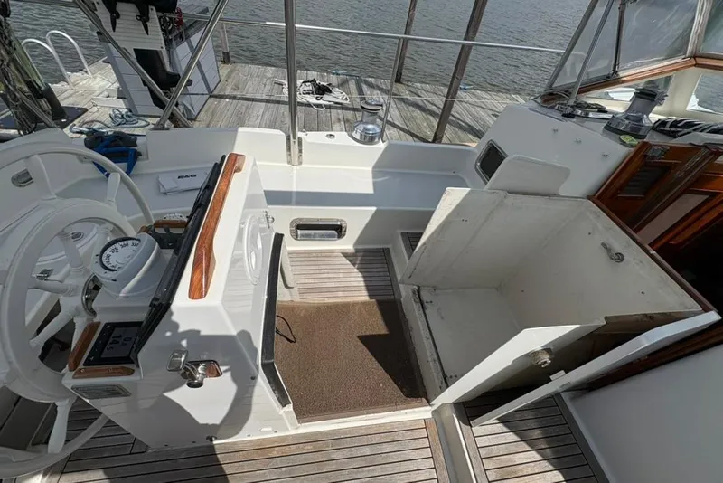 Slide: The Image of Cockpit of 2016 Gozzard 41 RC sailboat with steering wheel and navigation instruments. - 38