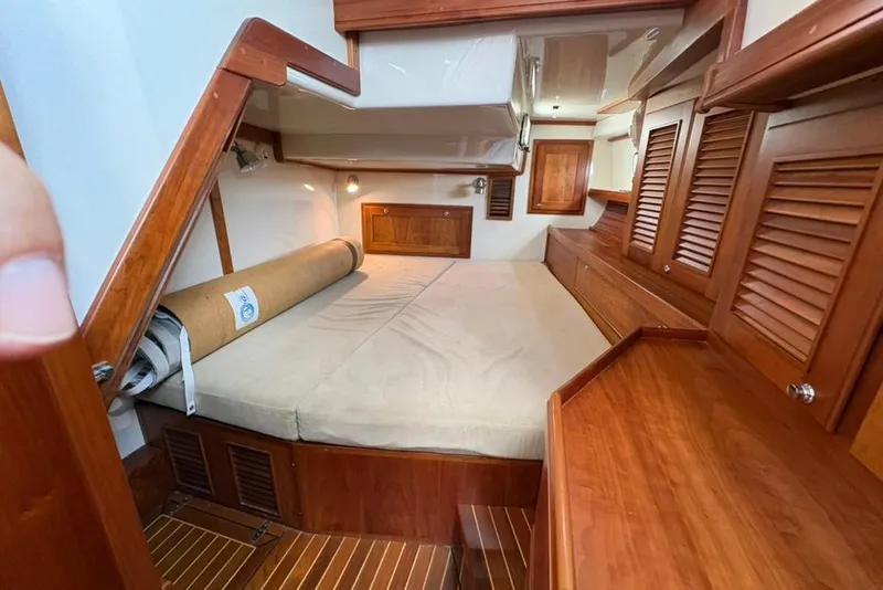 Slide: The Image of Interior of 2016 Gozzard 41 RC yacht with wooden cabinetry and cozy sleeping area. - 15