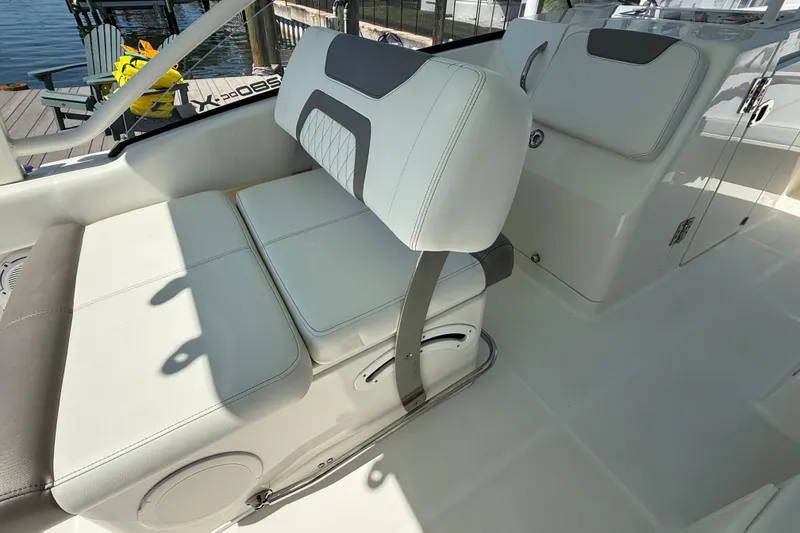 Slide: The Image of Luxury seating on 2021 World Cat 280 DC-X boat, featuring white and gray upholstery. - 10