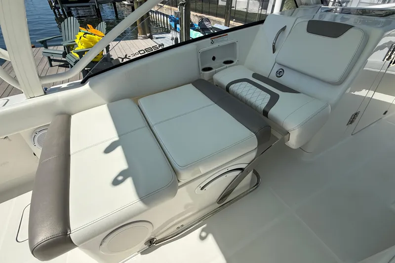Slide: The Image of 2021 World Cat 280 DC-X boat interior with cushioned seating and cup holders. - 12