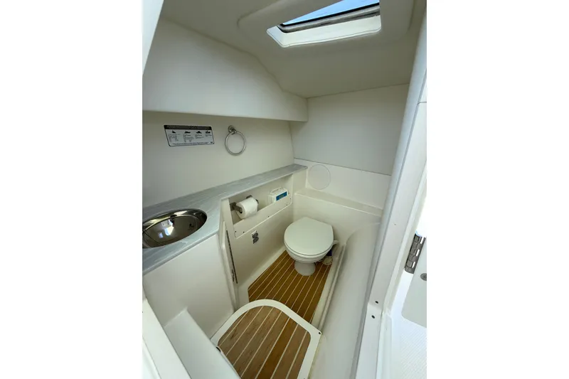Slide: The Image of Interior of 2021 World Cat 280 DC-X boat bathroom with toilet and sink. - 13