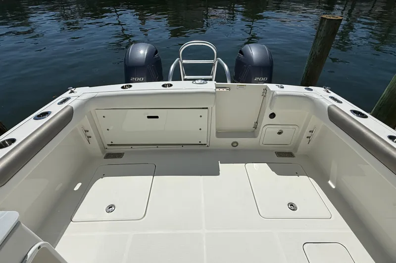 Slide: The Image of 2021 World Cat 280 DC-X boat deck with twin 200 engines, docked by water. - 15