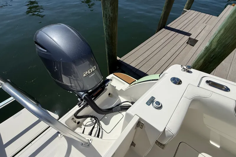Slide: The Image of 2021 World Cat 280 DC-X boat with Yamaha 200 engine docked by wooden pier. - 19