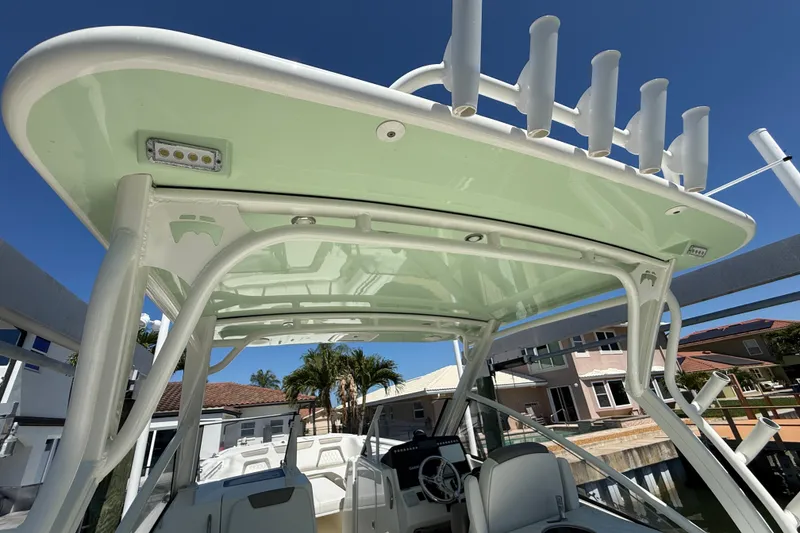 Slide: The Image of 2021 World Cat 280 DC-X boat with a sleek canopy and rod holders. - 22