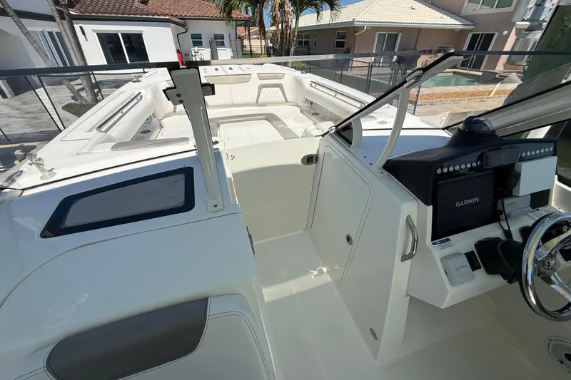 Slide: The Image of 2021 World Cat 280 DC-X boat interior with Garmin navigation system and spacious seating. - 23