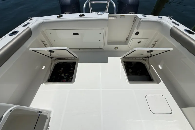 Slide: The Image of 2021 World Cat 280 DC-X boat deck with open storage compartments. - 24