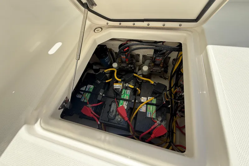 Slide: The Image of Battery compartment of 2021 World Cat 280 DC-X boat, showing wiring and connections. - 25