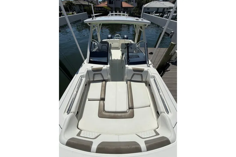 Slide: The Image of 2021 World Cat 280 DC-X boat with spacious seating and sleek design at a dock. - 3