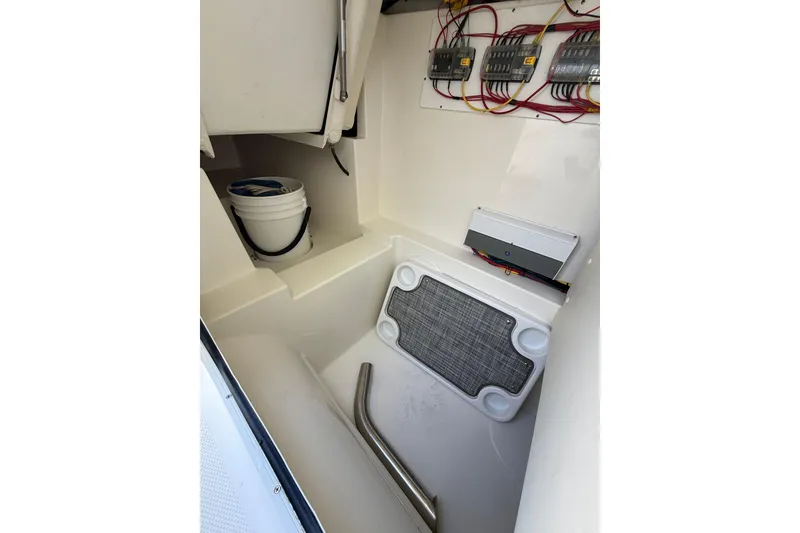 Slide: The Image of Interior of 2021 World Cat 280 DC-X boat, featuring storage and electrical components. - 4