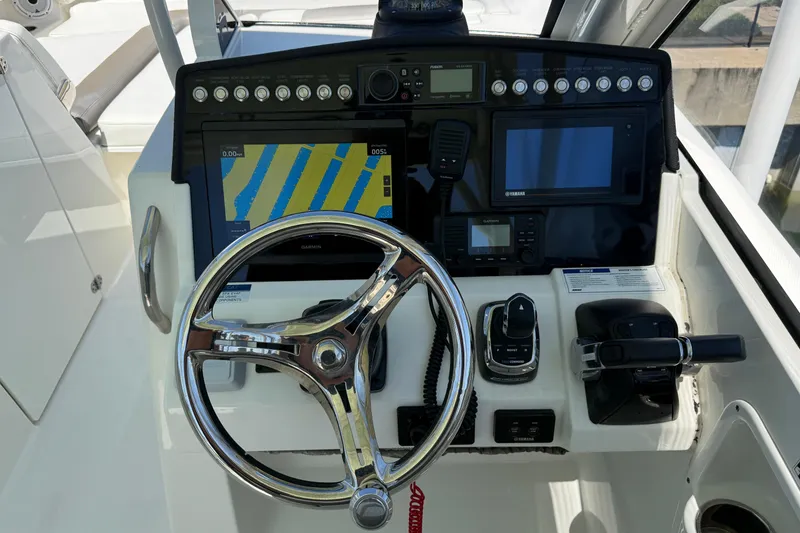 Slide: The Image of Steering console of 2021 World Cat 280 DC-X with navigation and control systems. - 6