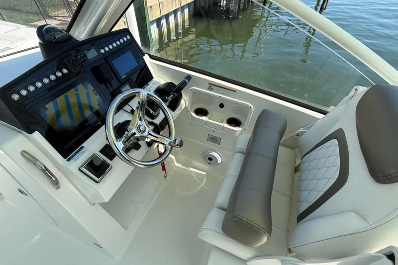 Slide: The Image of Helm of 2021 World Cat 280 DC-X boat with modern controls and comfortable seating. - 7