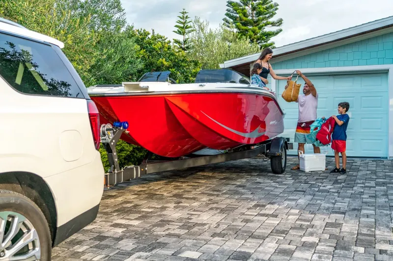 Slide: The Image of Family loading Bayliner M19 boat on trailer, 2024 model. - 2