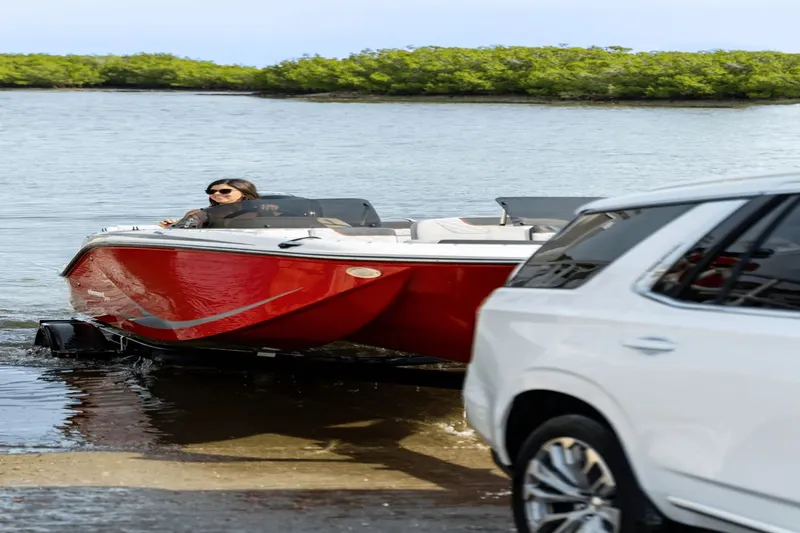 Slide: The Image of 2024 Bayliner M19 boat being launched into water. - 3