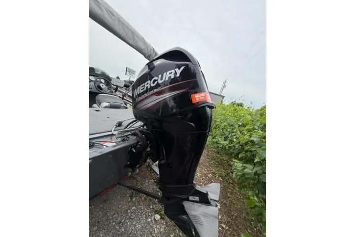 Slide: The Image of 2018 Tracker Pro 170 boat with Mercury outboard motor, parked on gravel. - 10