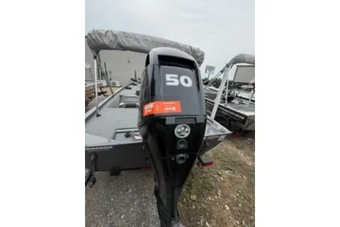 Slide: The Image of 2018 Tracker Pro 170 boat with a 50 HP outboard motor, parked outdoors. - 11
