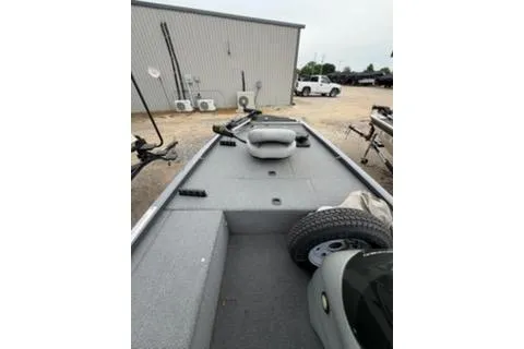 Slide: The Image of 2018 Tracker Pro 170 boat interior with fishing gear and spare tire. - 4