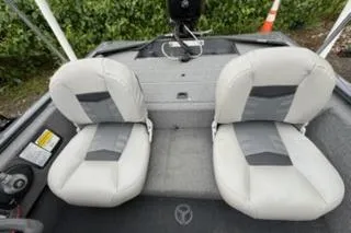 Slide: The Image of 2018 Tracker Pro 170 boat interior with two gray seats and control panel. - 5