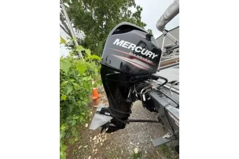 Slide: The Image of 2018 Tracker Pro 170 boat with Mercury outboard motor, parked outdoors. - 9