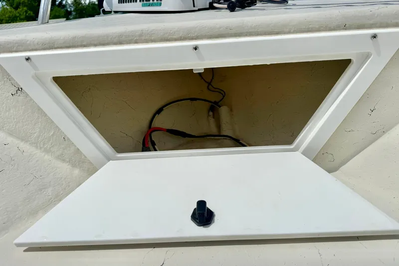 Slide: The Image of Open storage compartment on a 2014 May-Craft 1800 Skiff boat, showing interior wiring. - 13