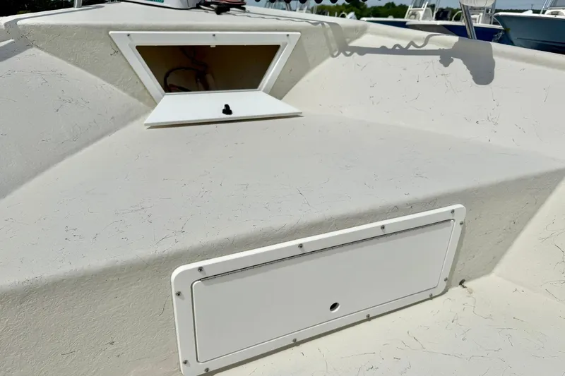 Slide: The Image of 2014 May-Craft 1800 Skiff boat deck with open storage compartments. - 14