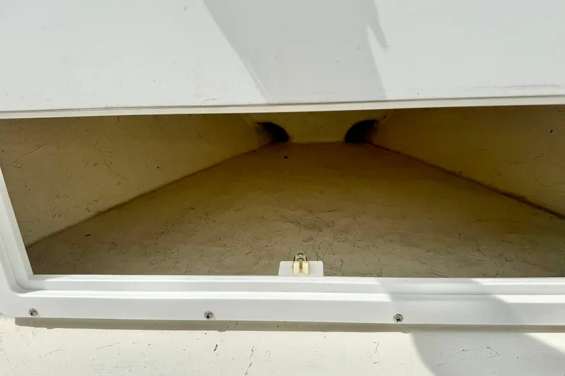 Slide: The Image of Storage compartment of a 2014 May-Craft 1800 Skiff boat, open and empty. - 15